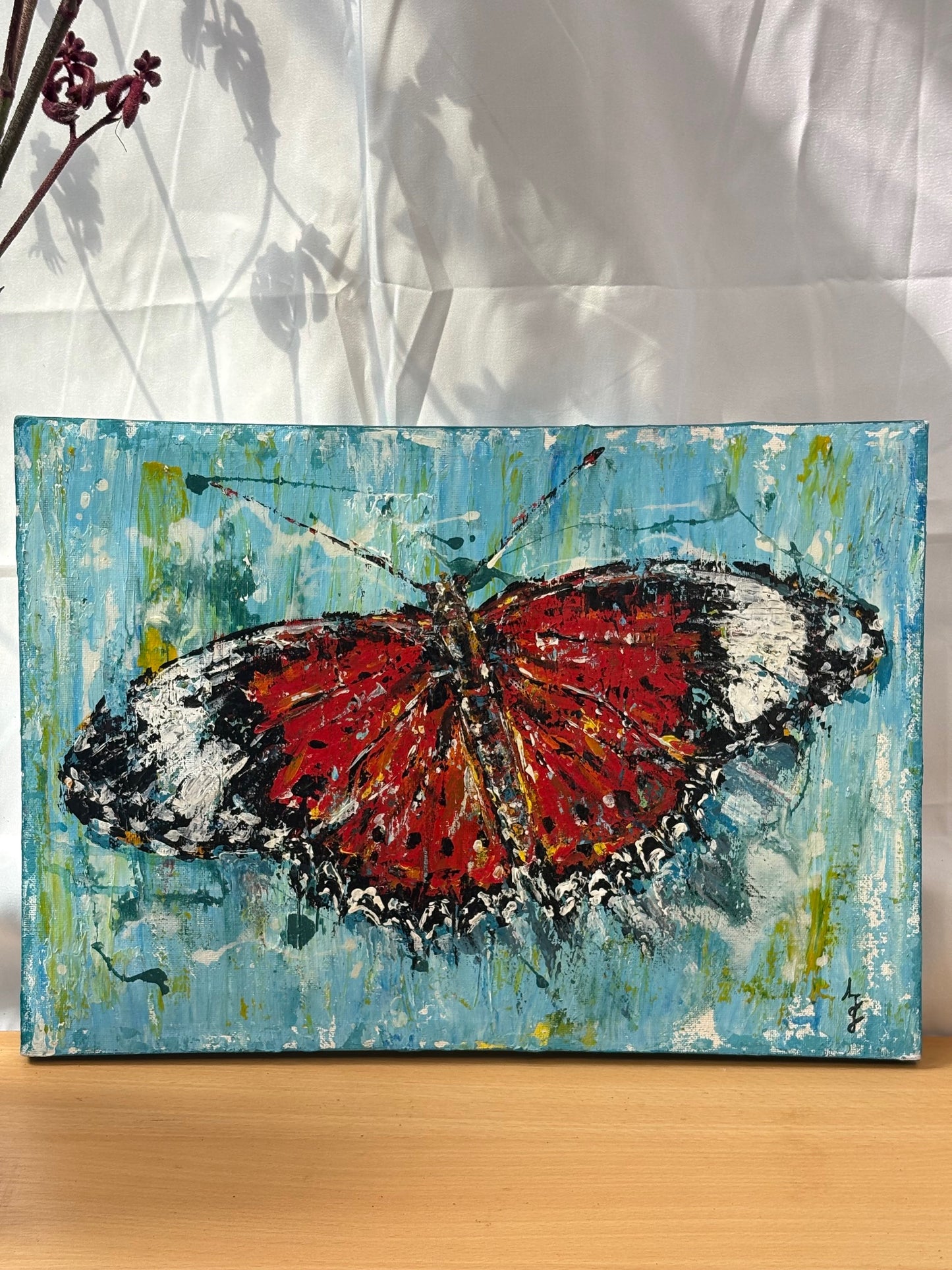 Painting of a butterfly on a textured blue background